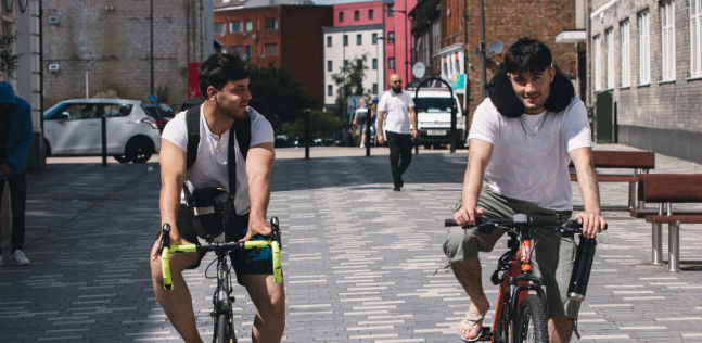 Two men on bikes Two men on bicycles, pedaling along a scenic route, highlighting an active lifestyle and friendship.